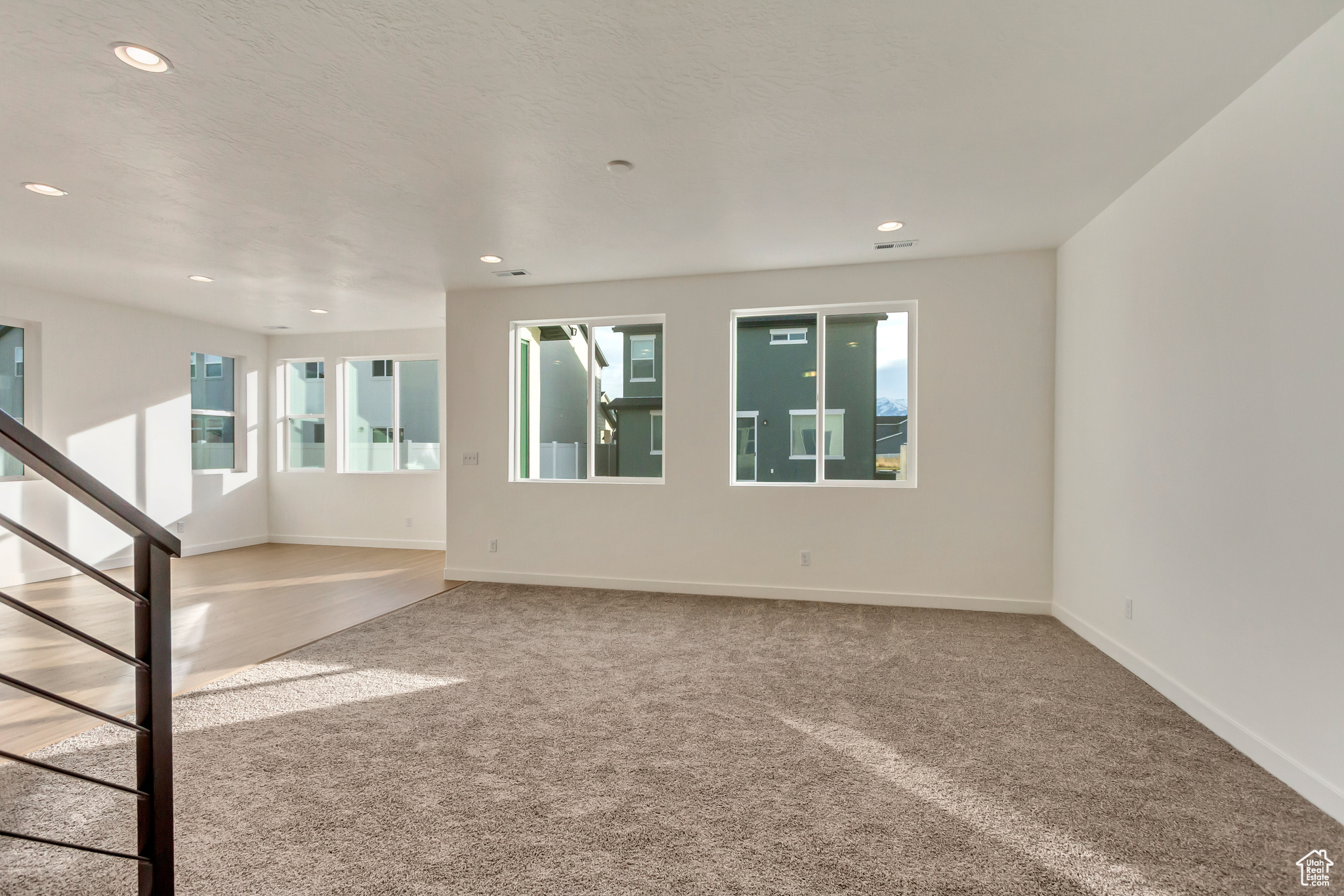 Unfurnished living room featuring carpet flooring