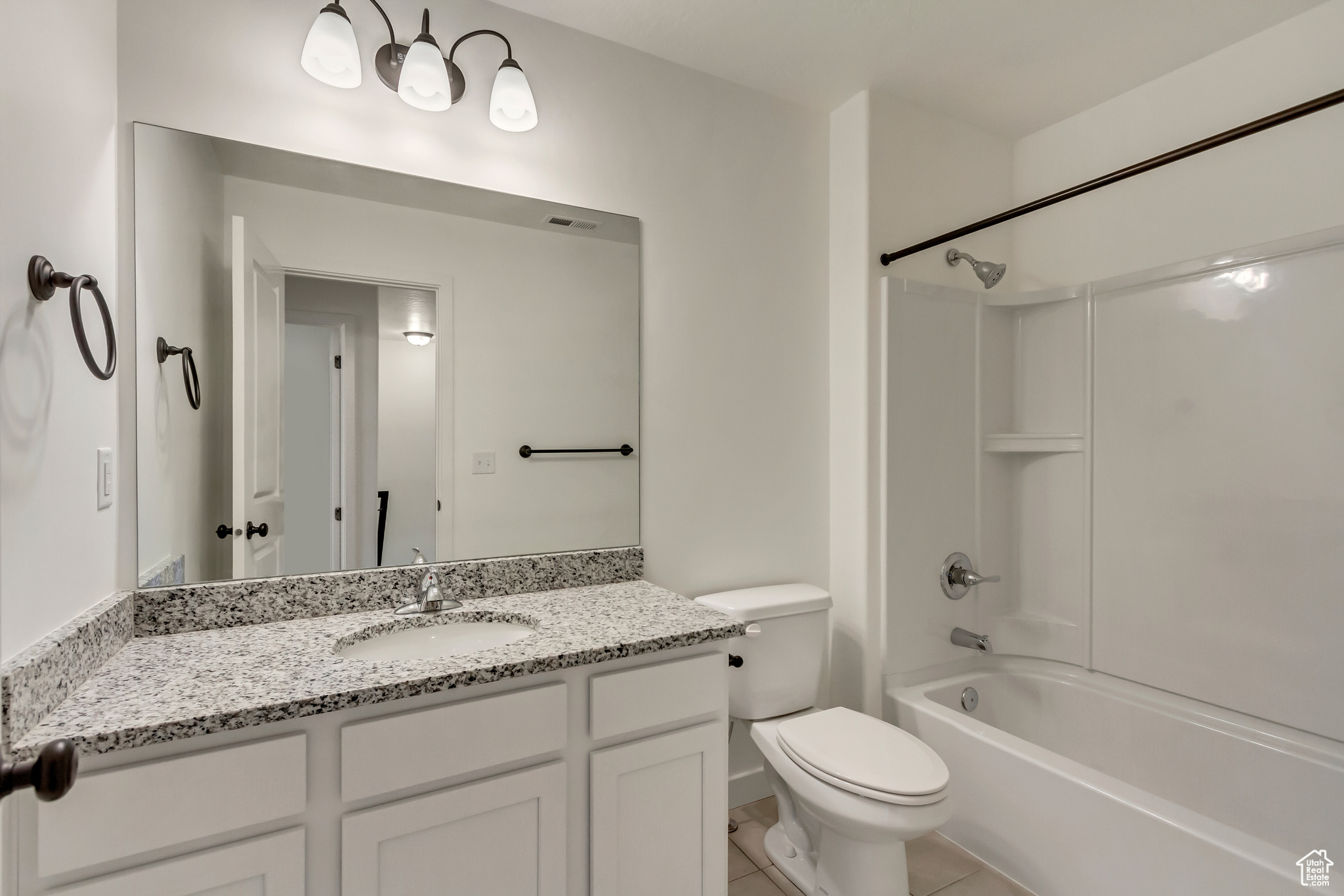 Full bathroom featuring shower / bathing tub combination, vanity, toilet, and tile patterned floors