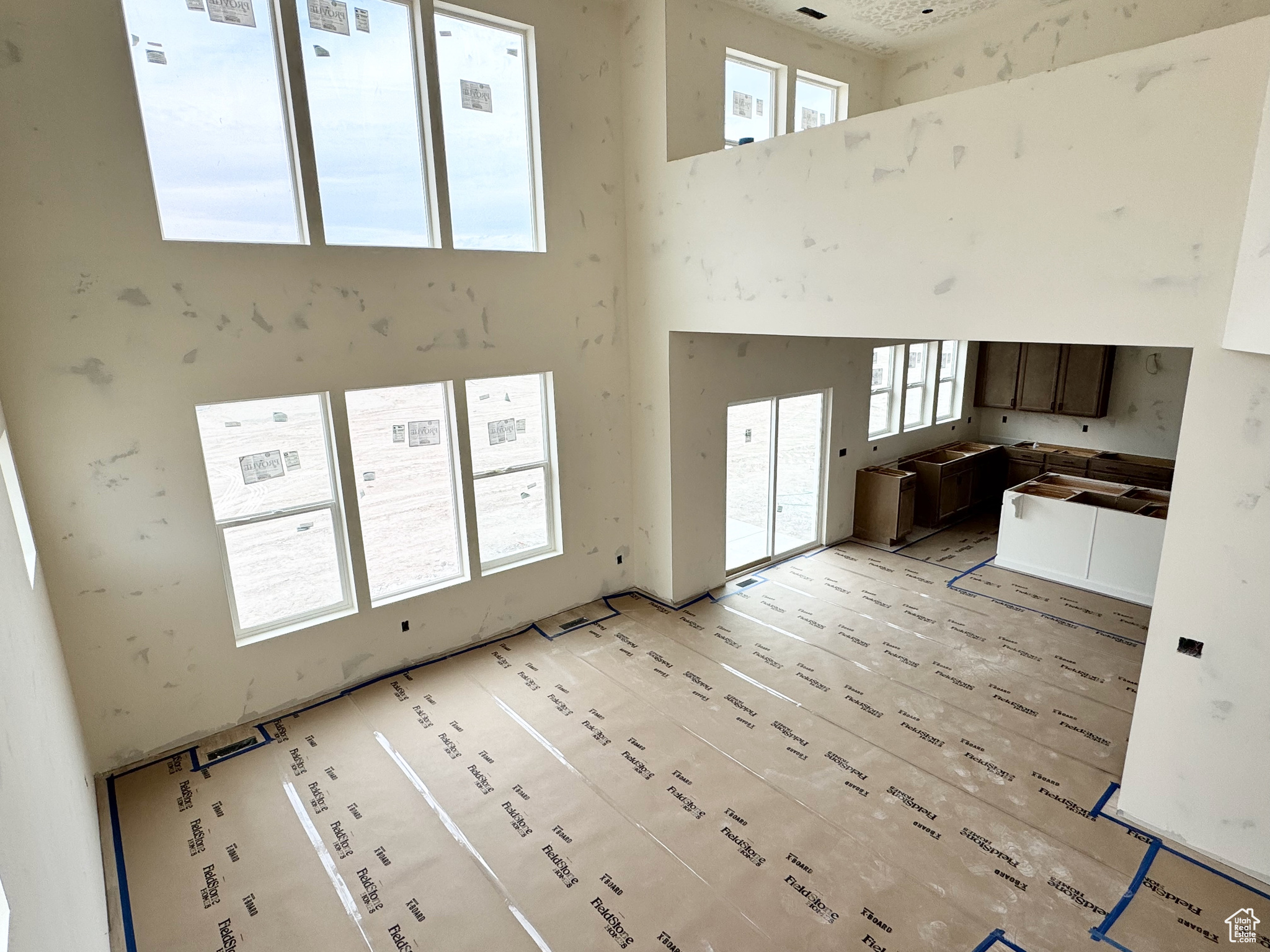 Unfurnished living room with a high ceiling