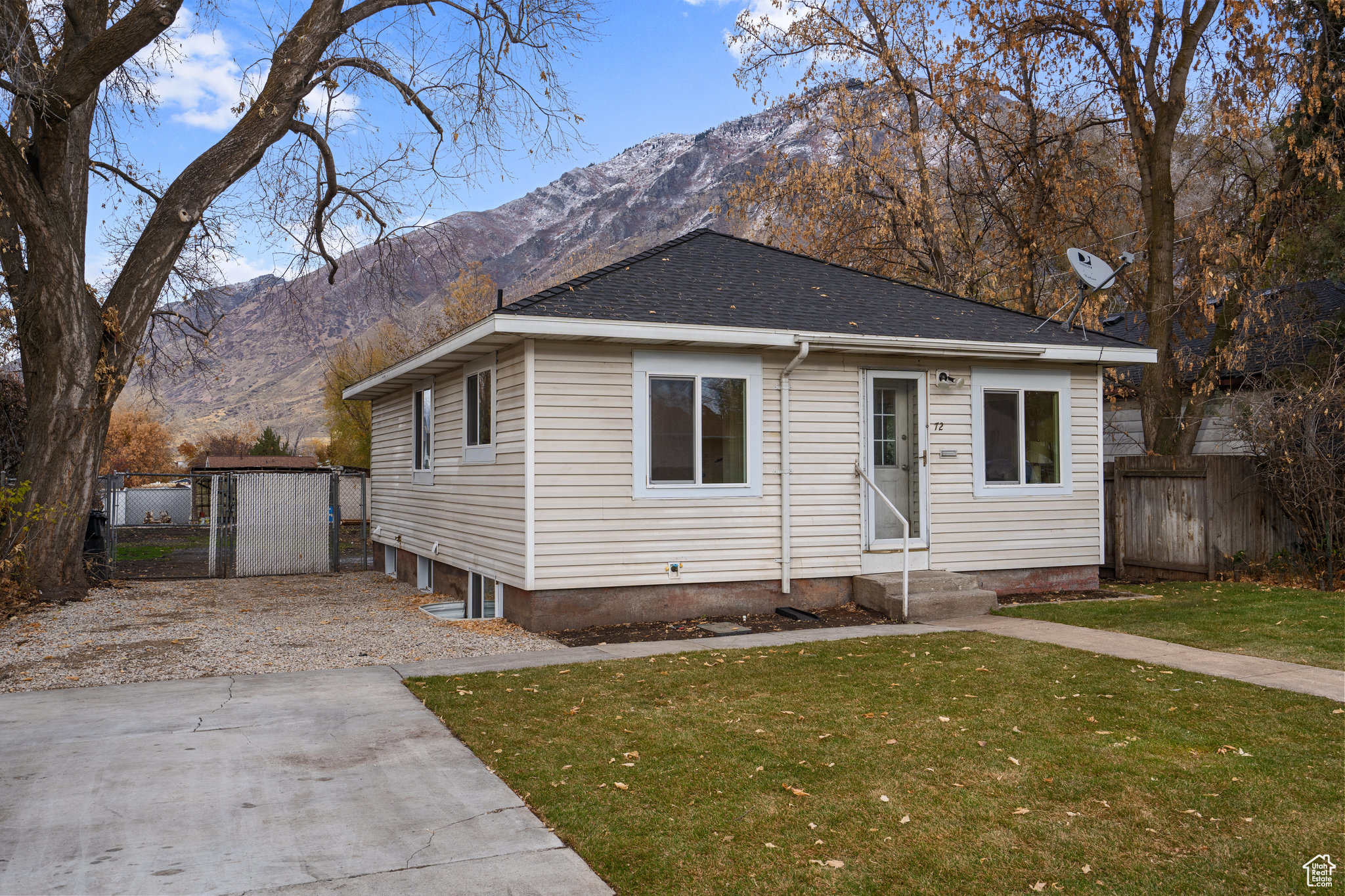 View of front of house with a mountain view and a front yard