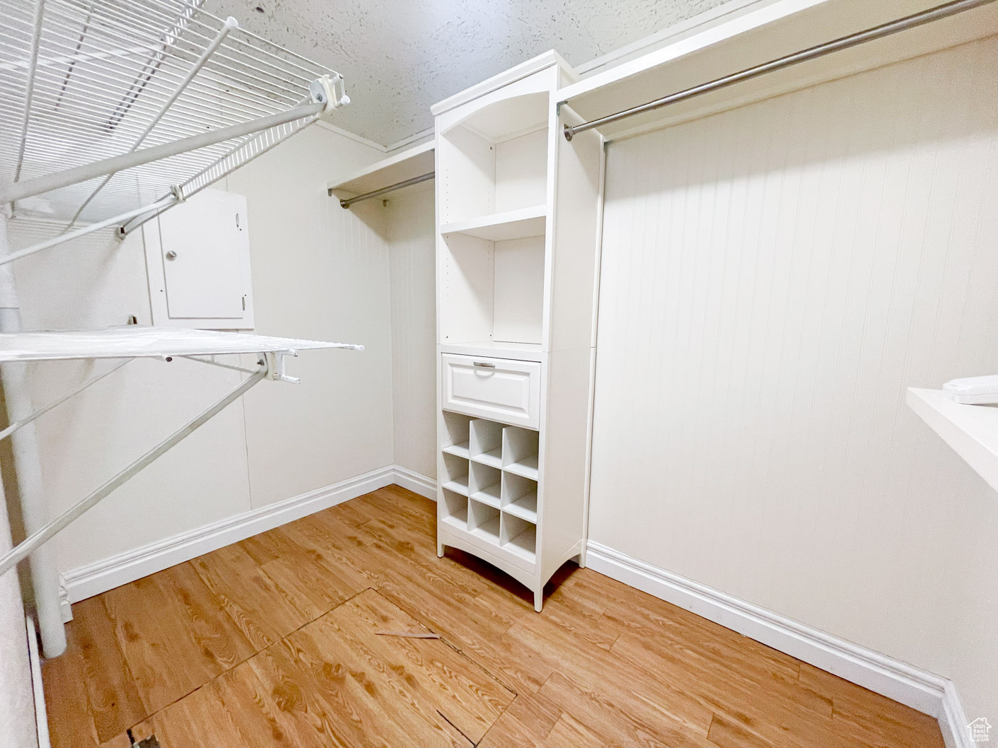 Walk in closet for main bedroom.  Closet featuring wood-type flooring