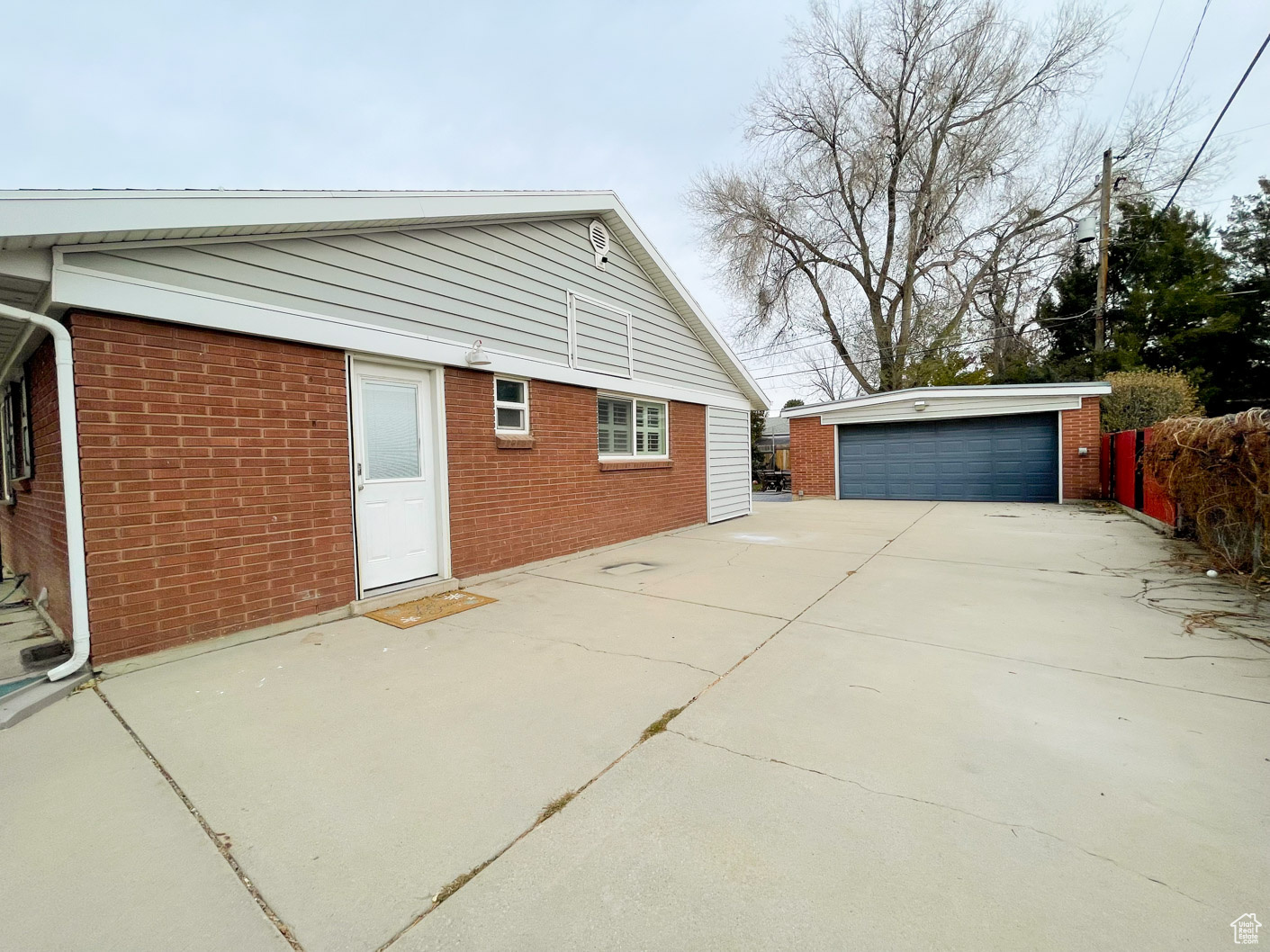 View of property exterior featuring an outbuilding and a garage