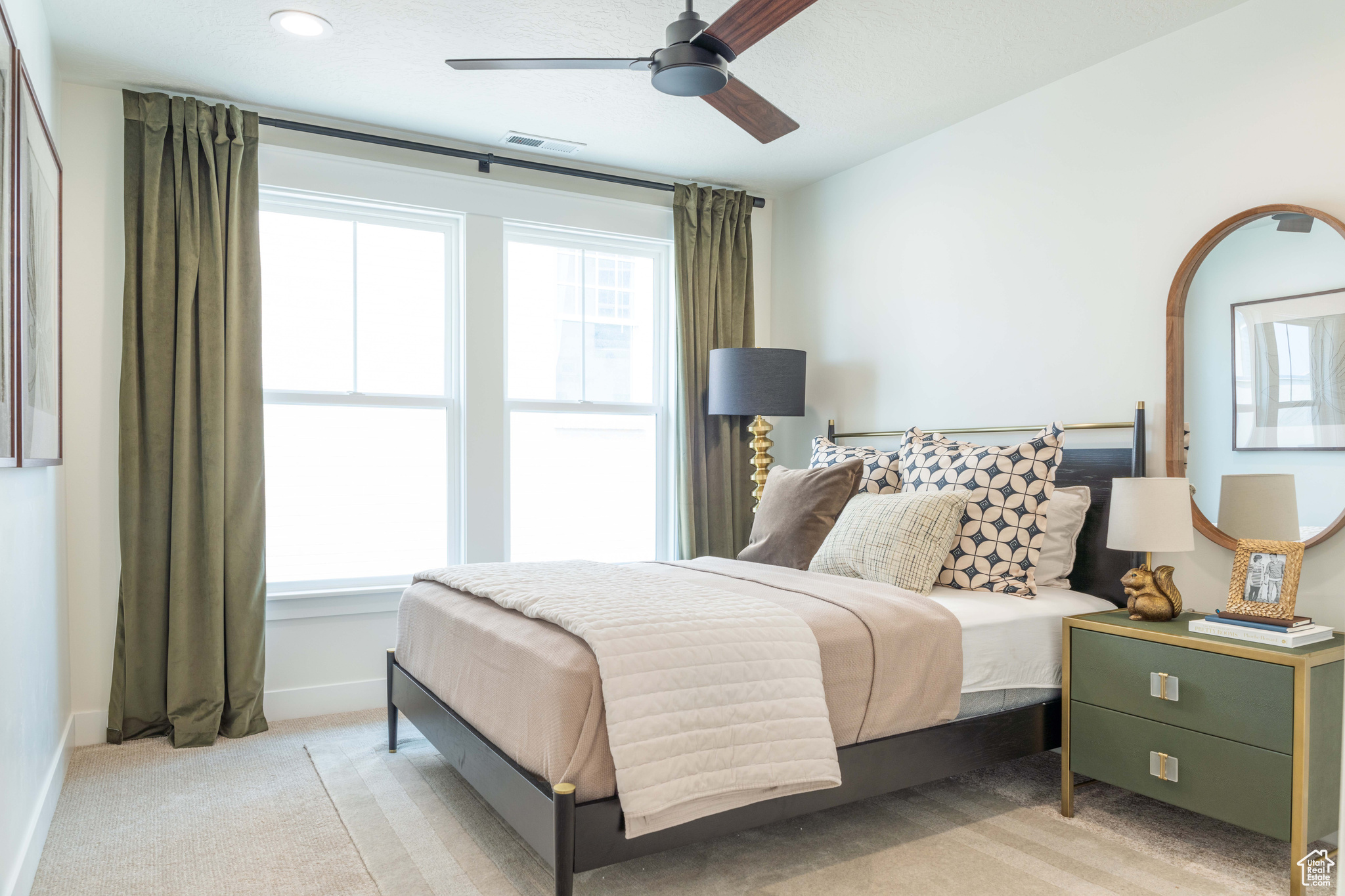 Carpeted bedroom featuring ceiling fan