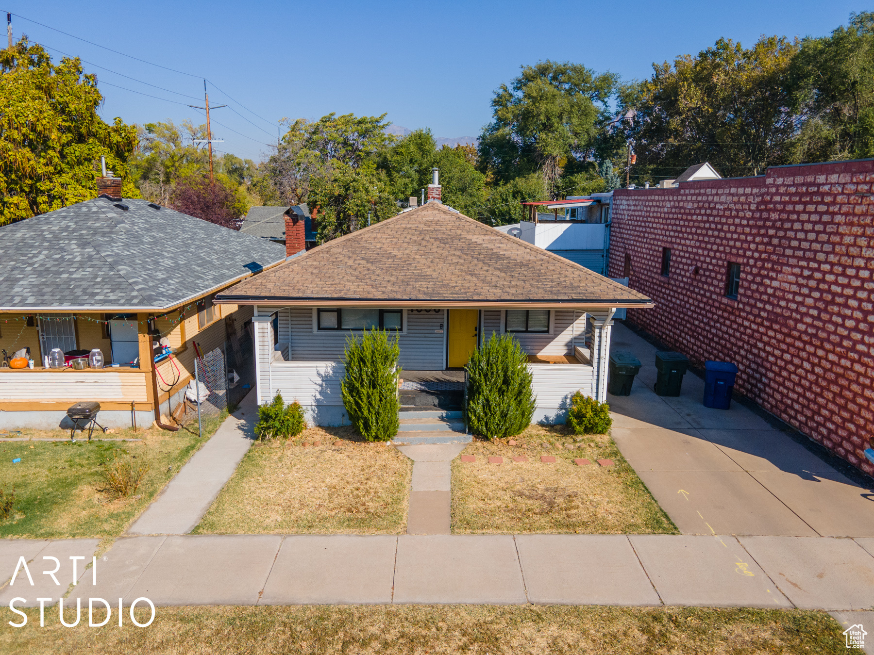 View of front of property with a porch and a carport