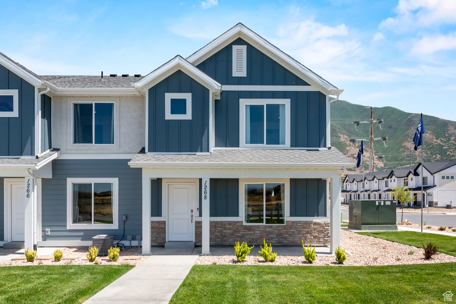 View of front of home featuring a front yard and central AC