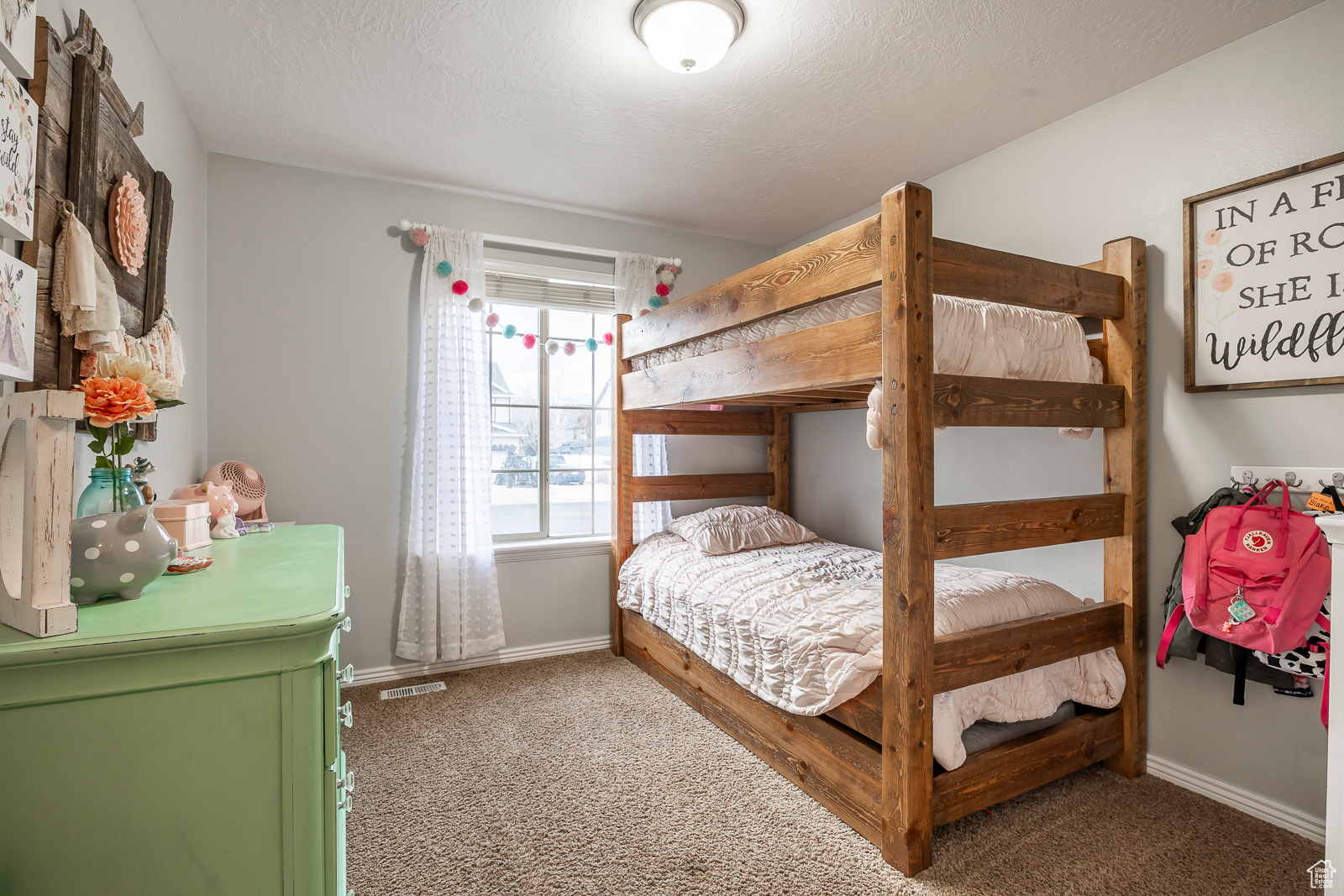 Bedroom with carpet flooring and a textured ceiling