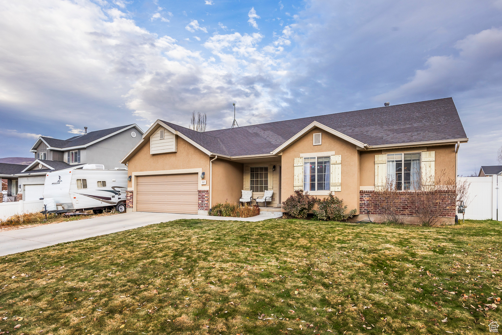 Ranch-style house with a front yard and a garage