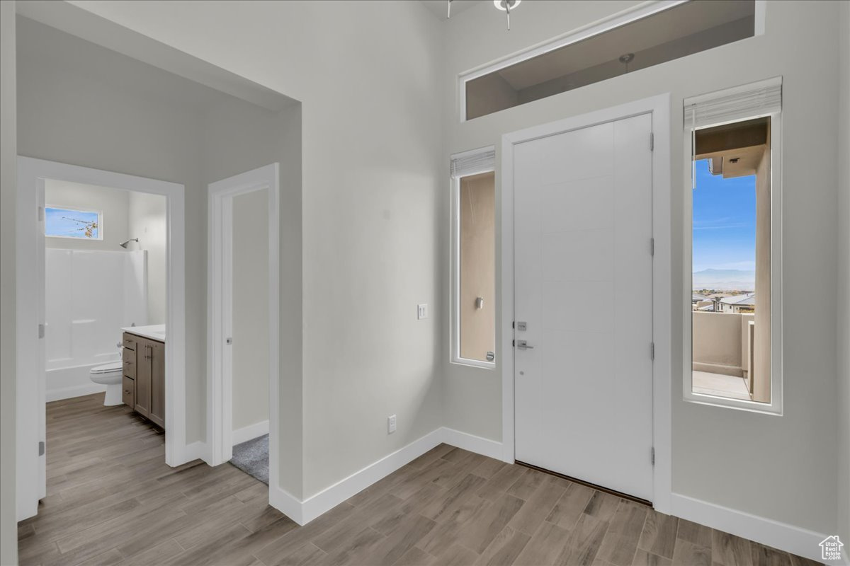 Entrance foyer with light wood-type flooring