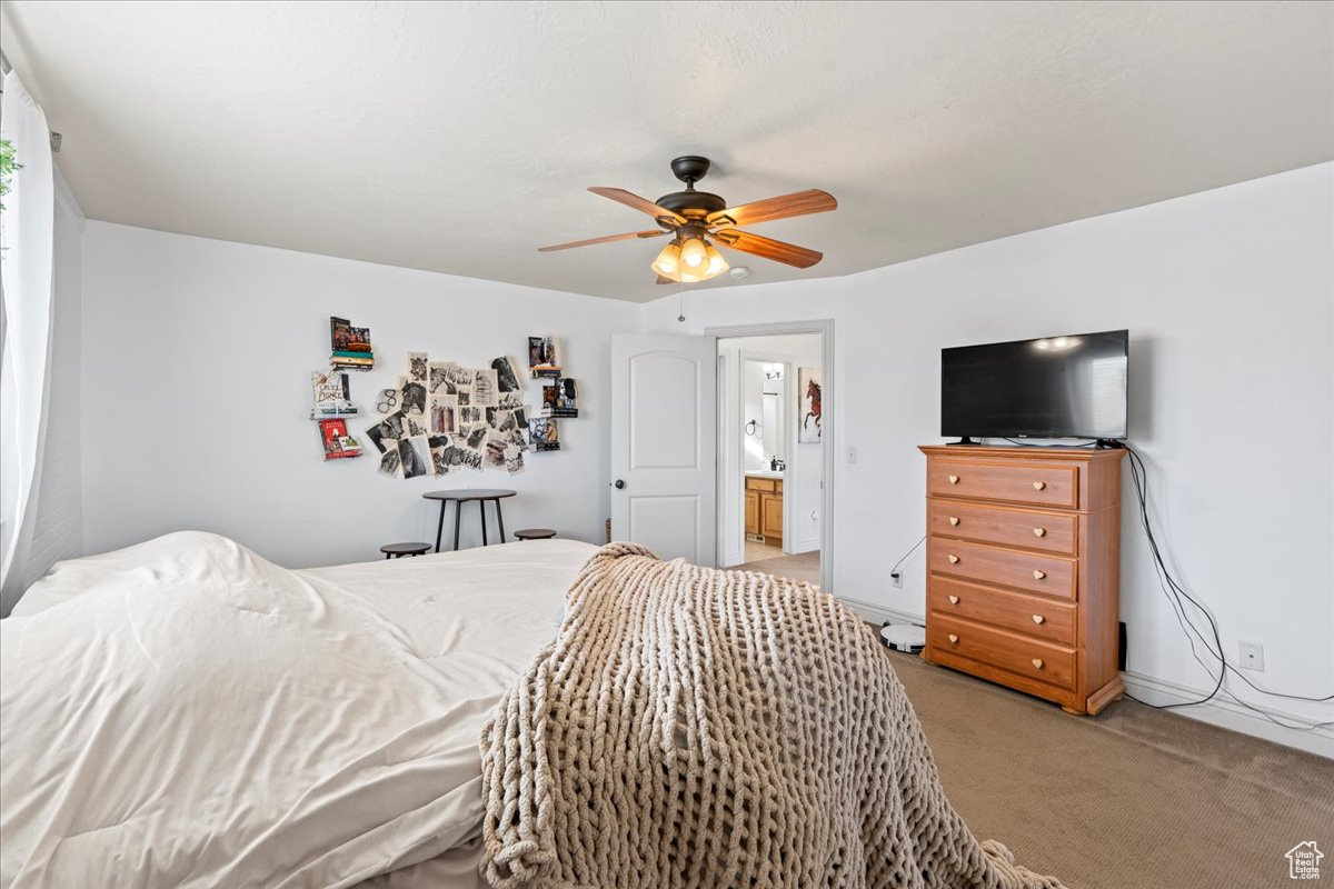 Carpeted bedroom with ceiling fan