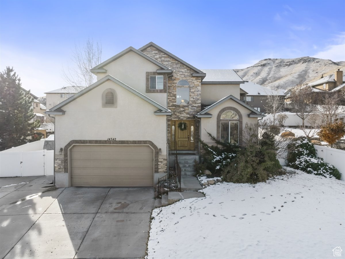 Front facade with a mountain view and a garage