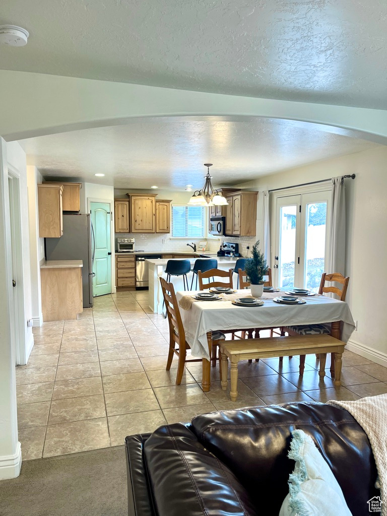 Tiled dining room with a textured ceiling