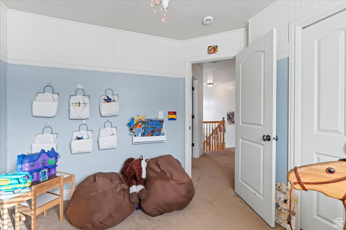 Rec room with light colored carpet