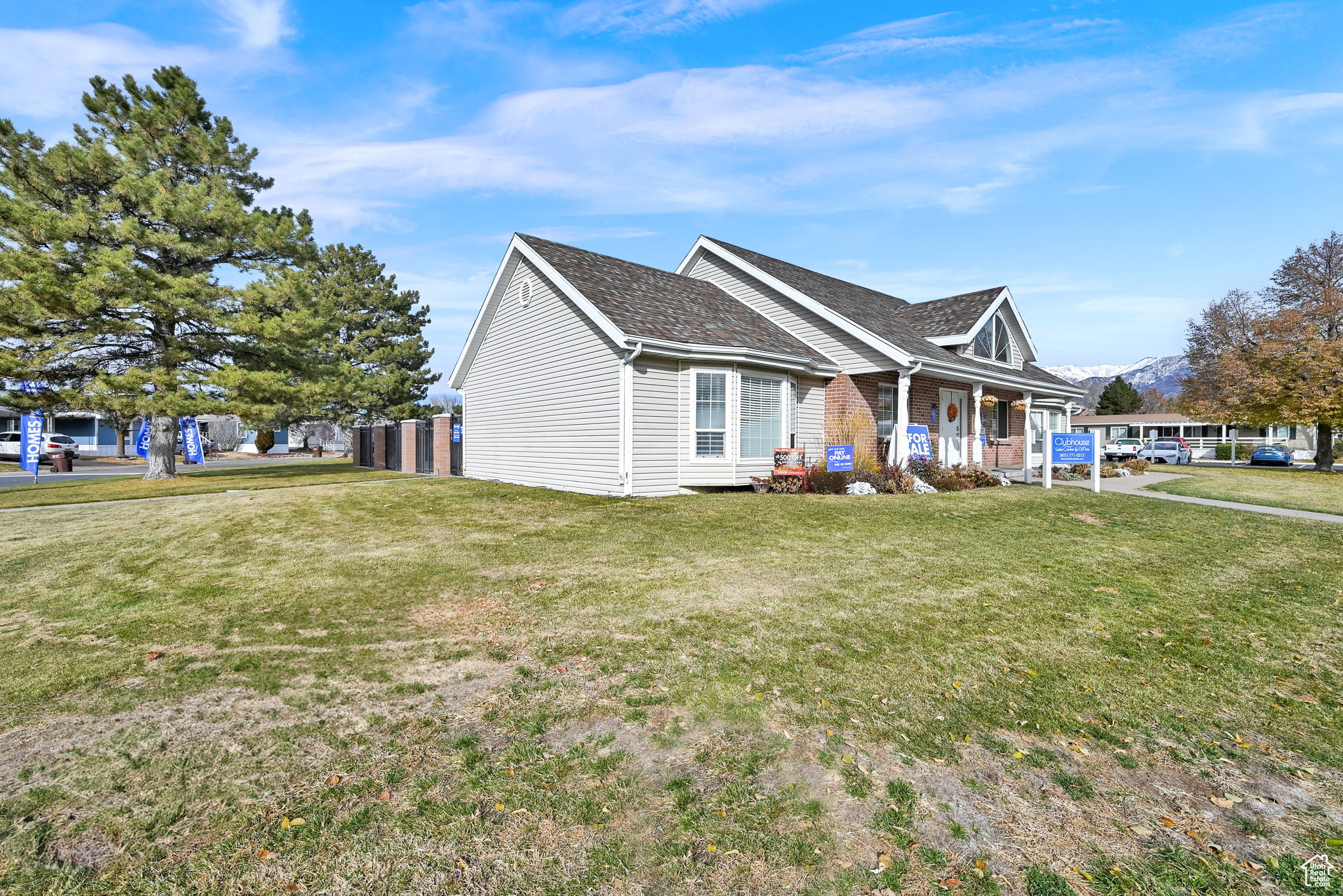 View of front of property with covered porch and a front lawn