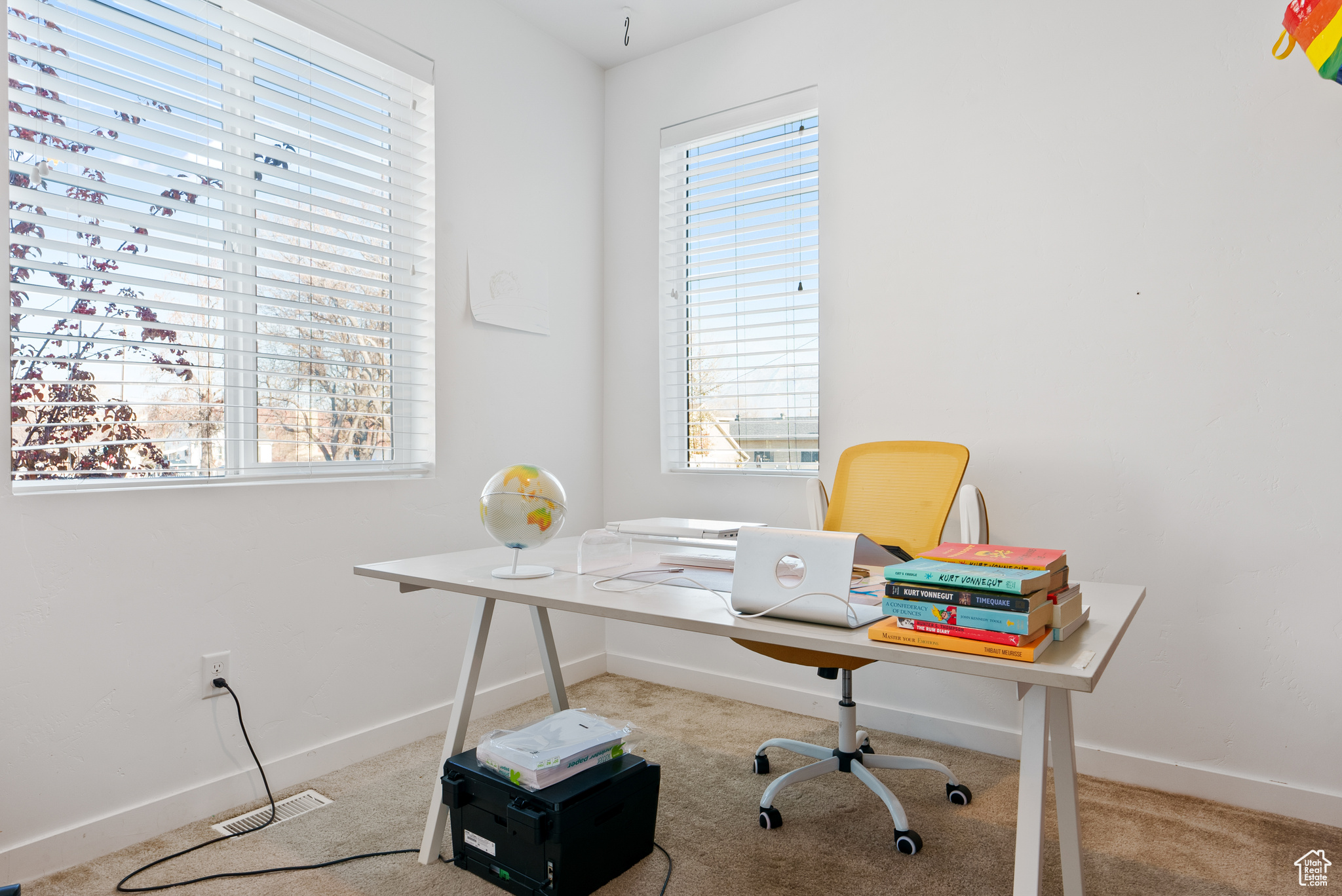 Carpeted office with plenty of natural light