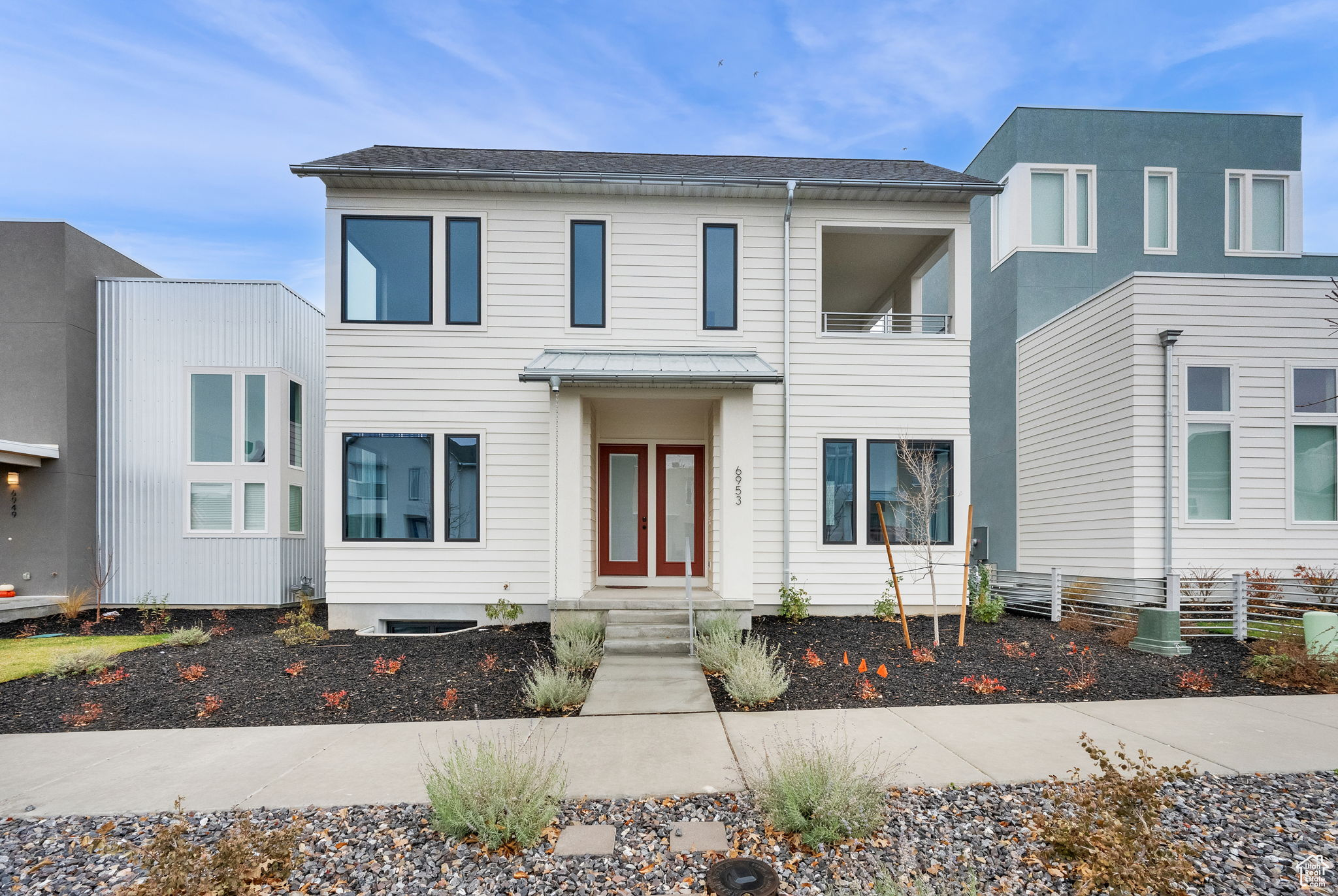 View of front of property with a balcony