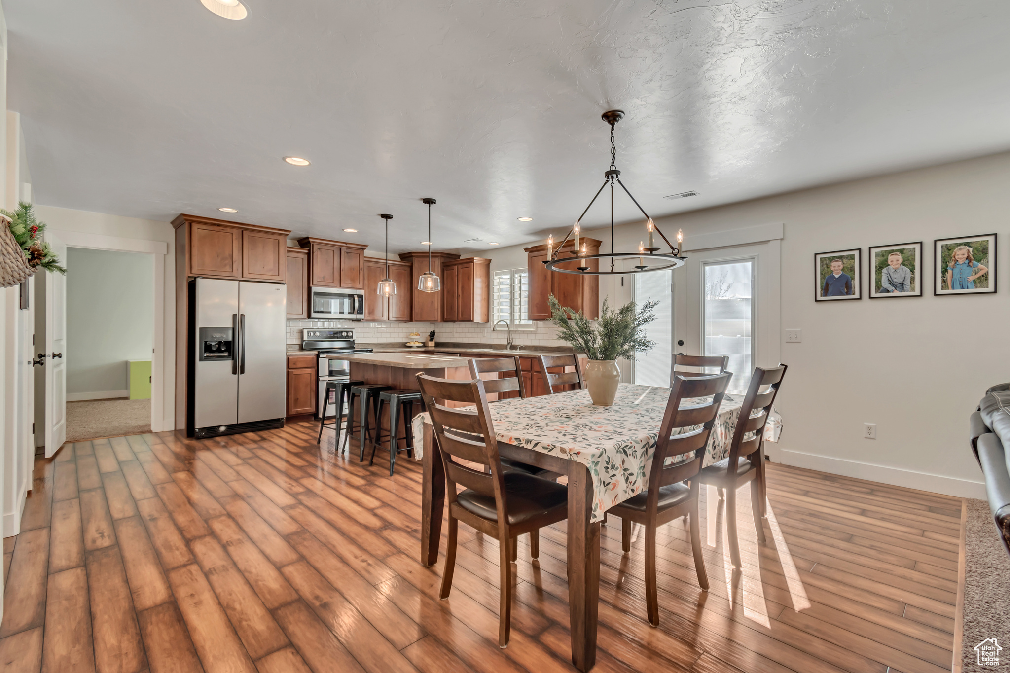 Dining space featuring a notable chandelier, light hardwood / wood-style floors, and sink