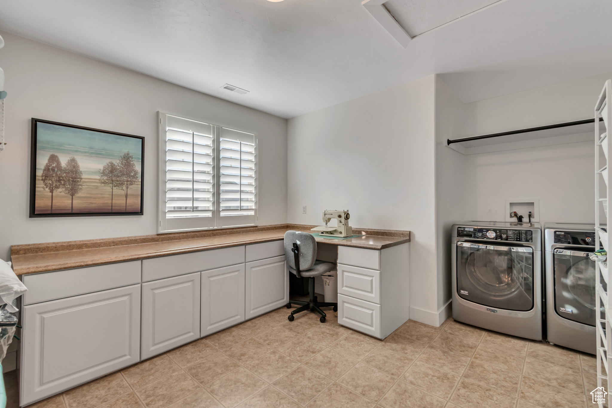 Washroom with cabinets and washer and dryer