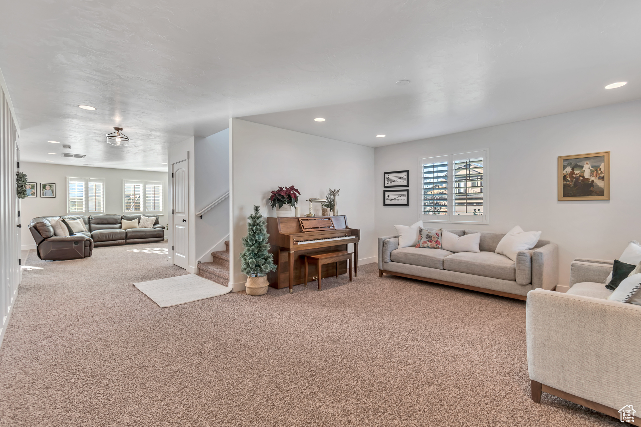 Living room with carpet flooring and plenty of natural light