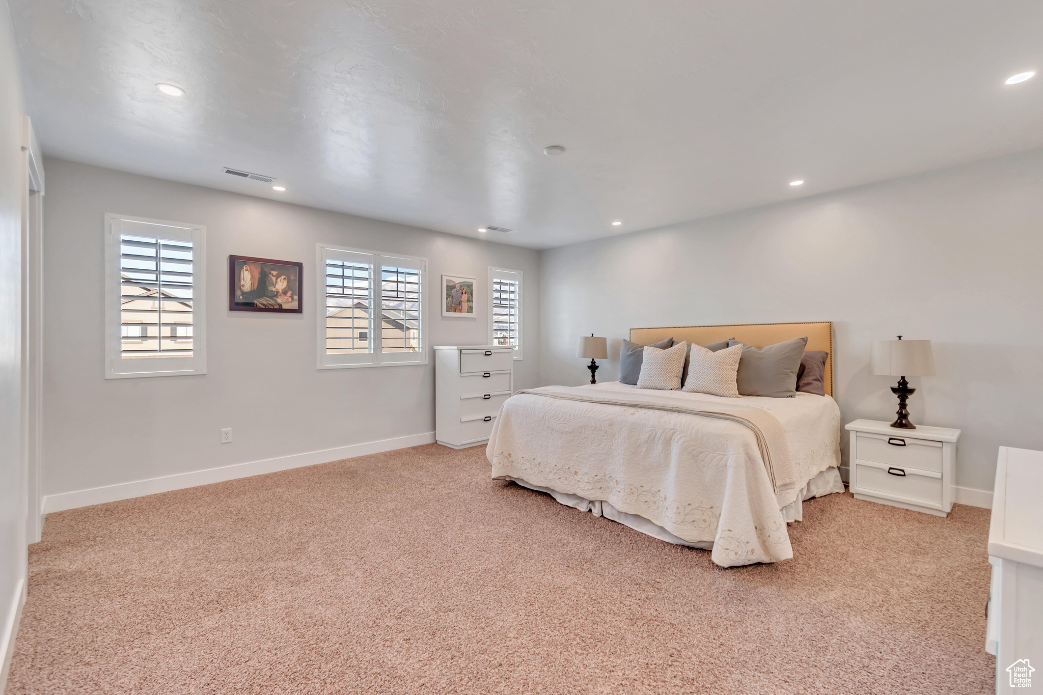 Bedroom with light colored carpet