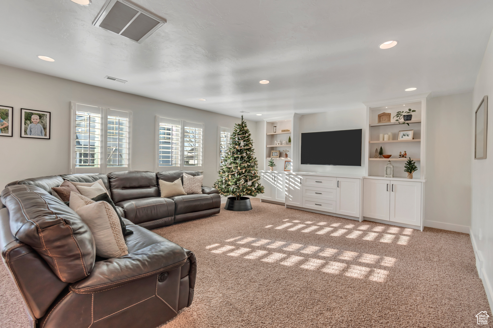 Carpeted living room with built in shelves