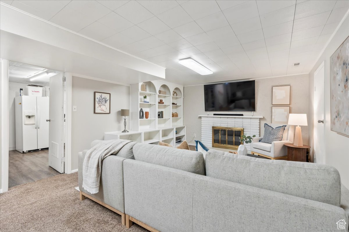 Carpeted living room with a fireplace