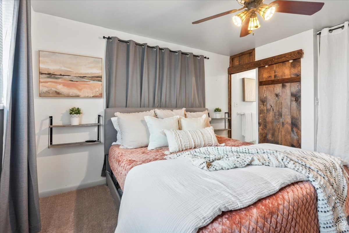 Carpeted bedroom with ceiling fan