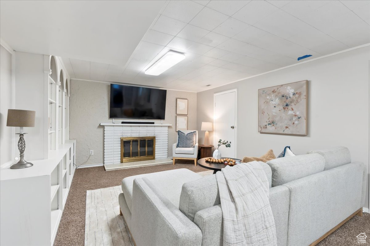 Living room with carpet and a brick fireplace