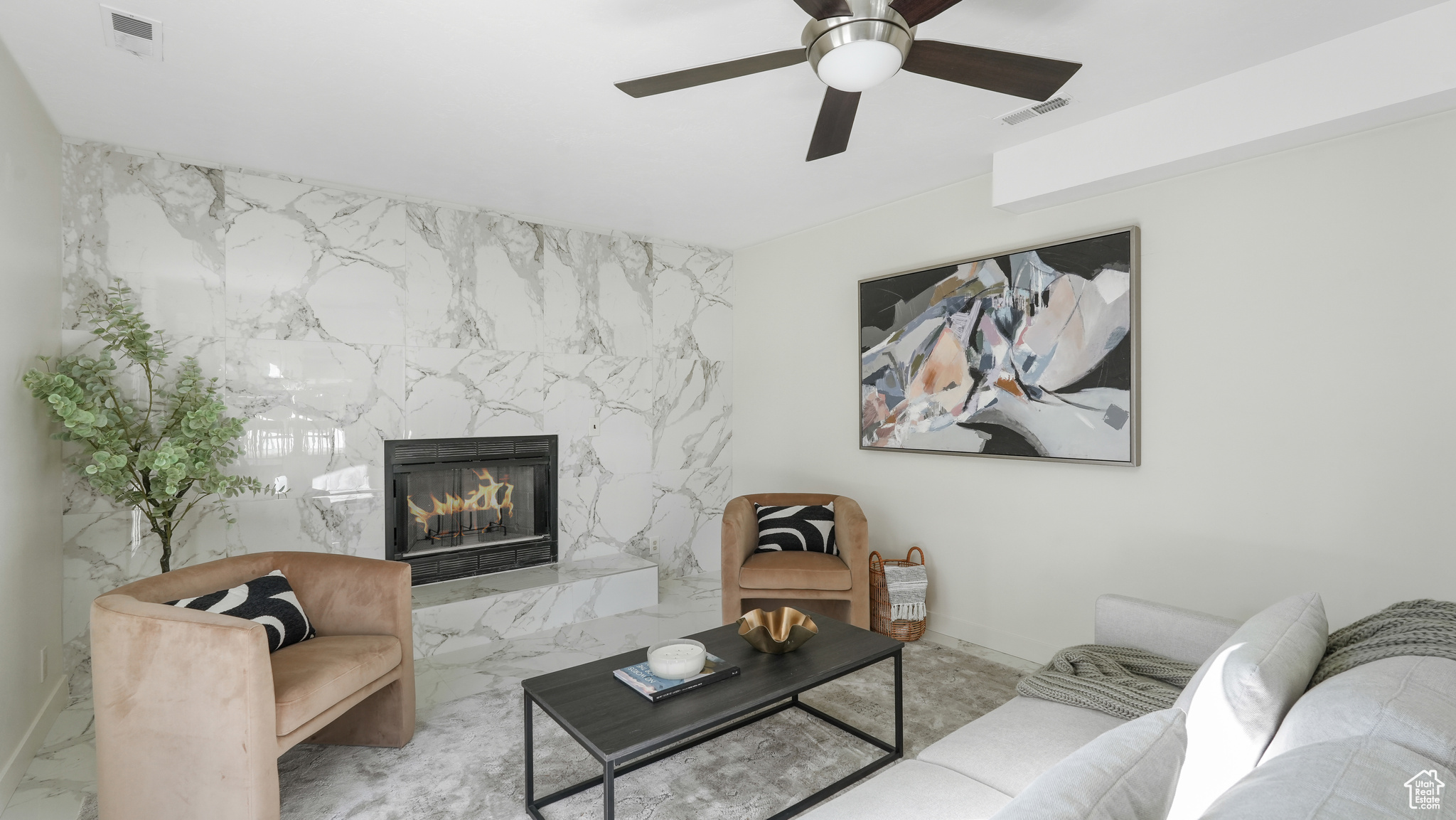 Living room featuring ceiling fan and a premium fireplace