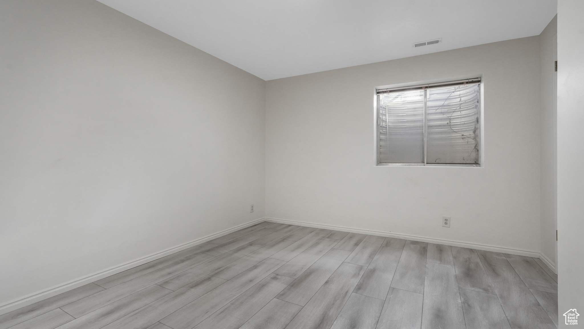 Bedroom with light hardwood / wood-style flooring