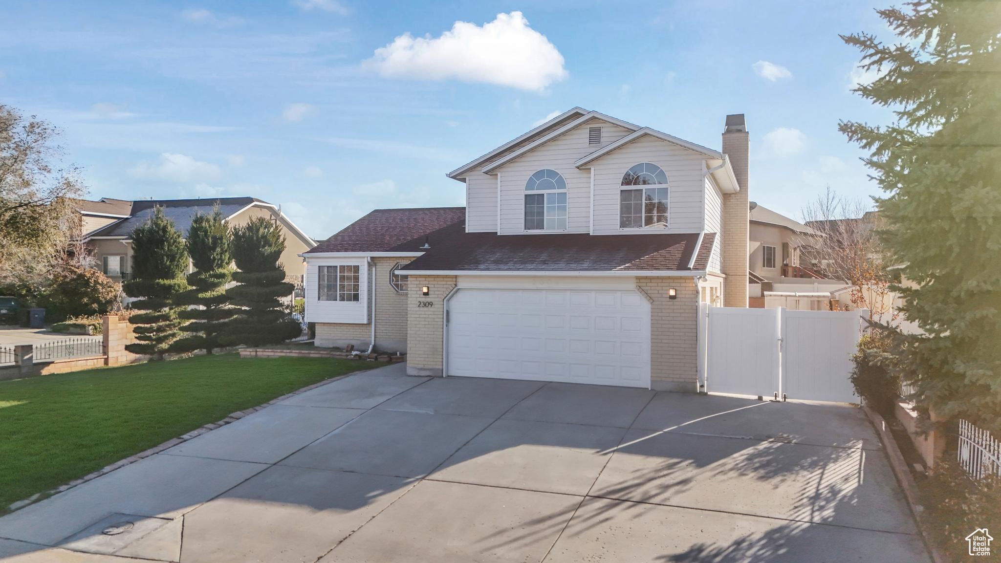 View of property with a garage and a front yard