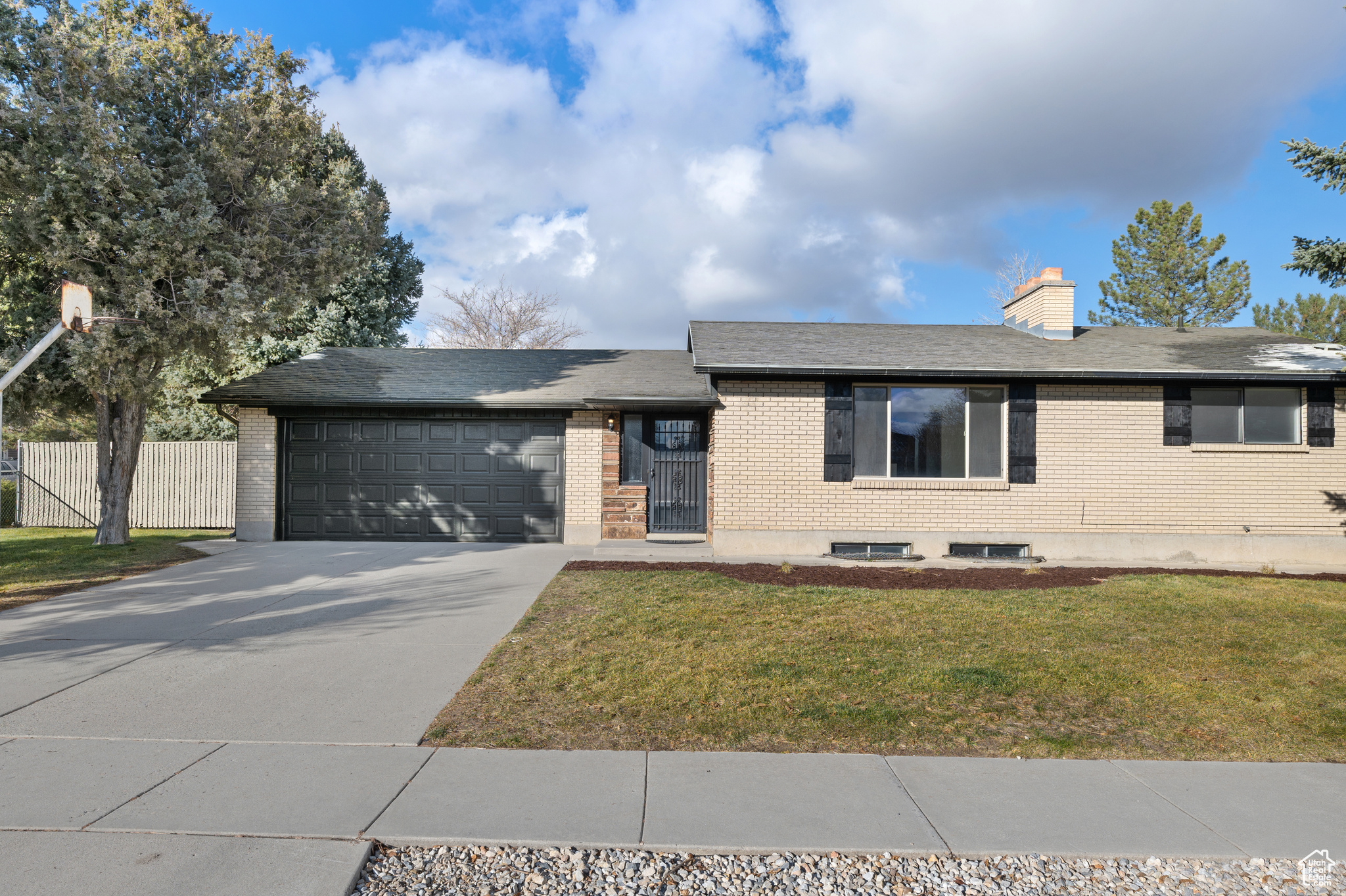 View of front of house with a garage and a front lawn