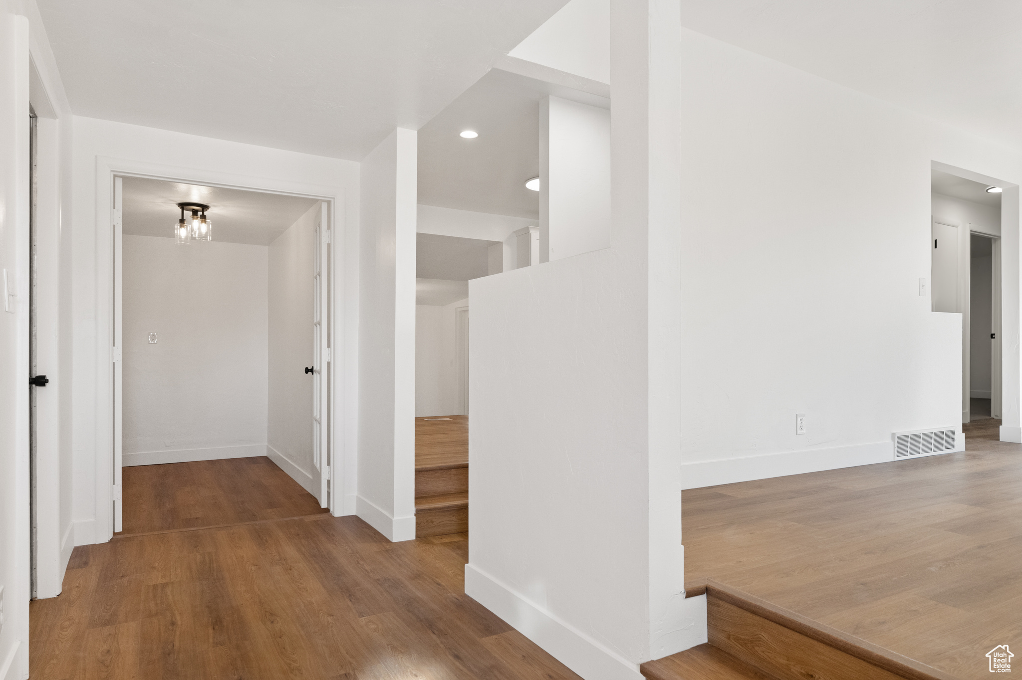 Corridor with hardwood / wood-style flooring