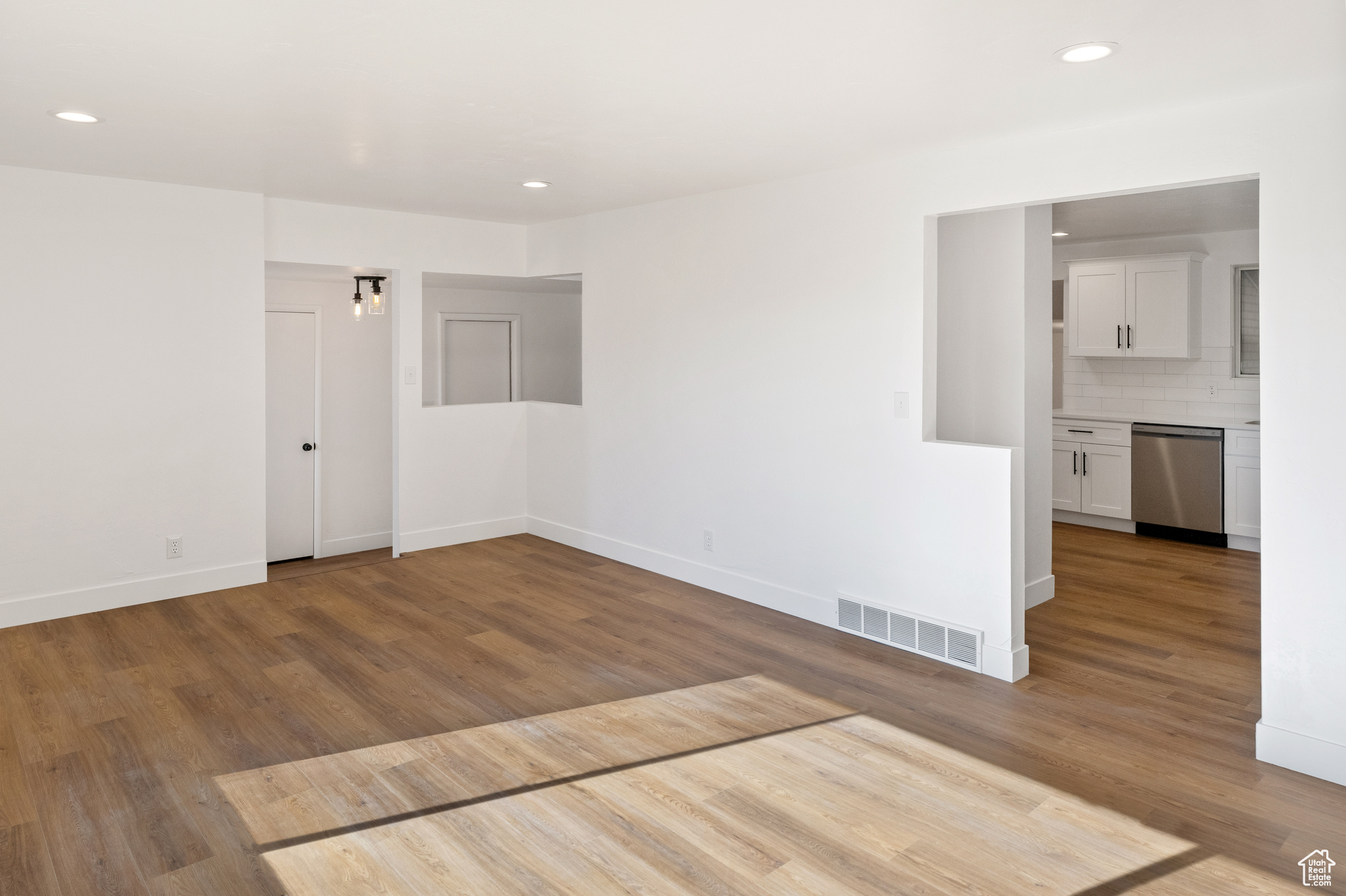 Empty room with hardwood / wood-style floors