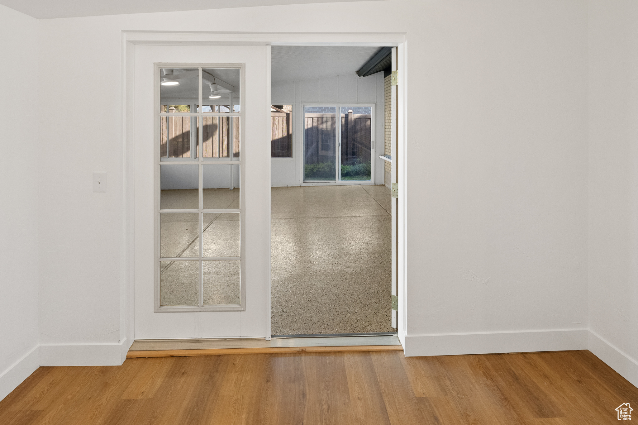 Unfurnished room featuring lofted ceiling with beams and hardwood / wood-style flooring