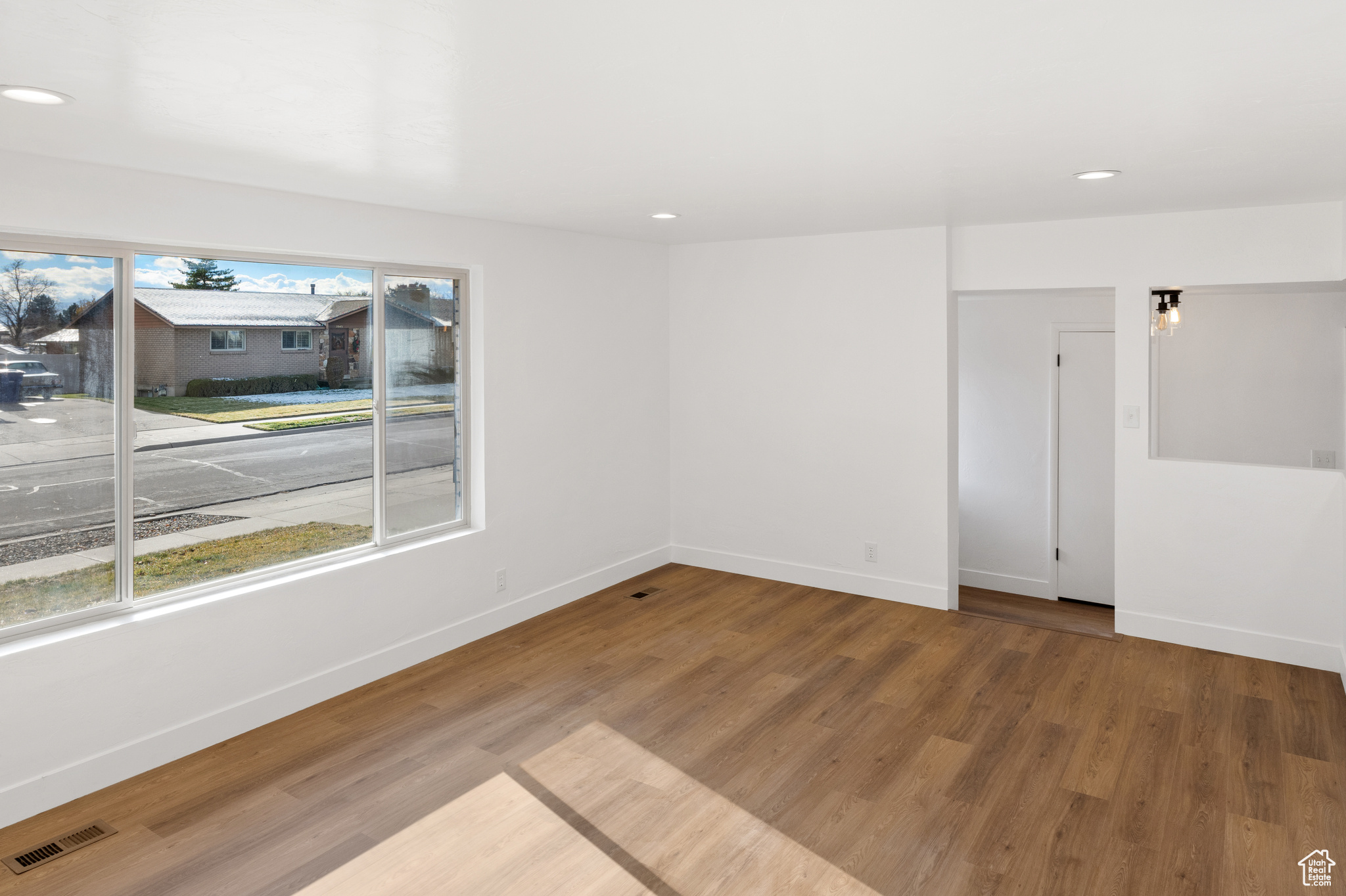 Empty room with hardwood / wood-style flooring