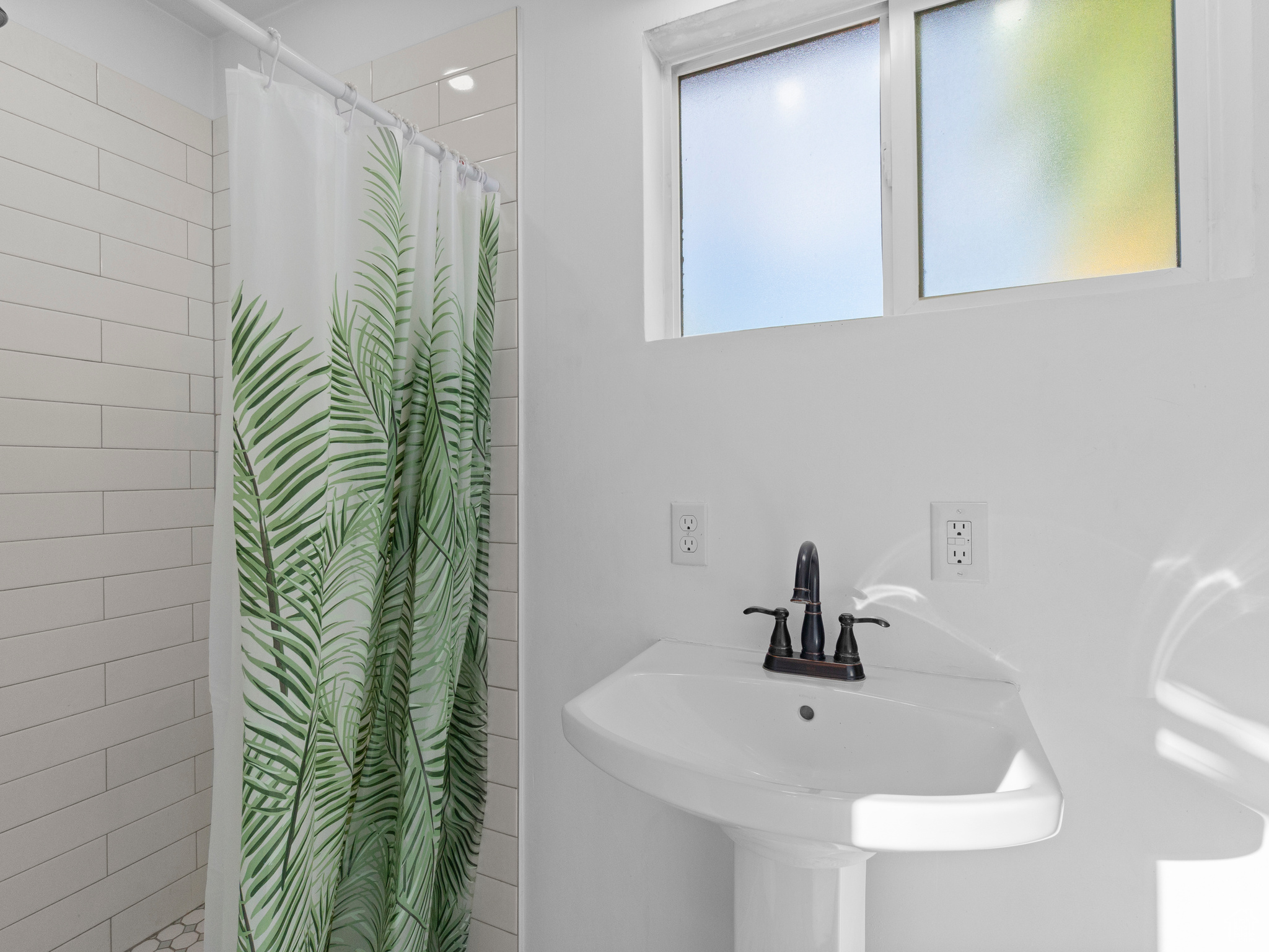 Bathroom featuring curtained shower and sink