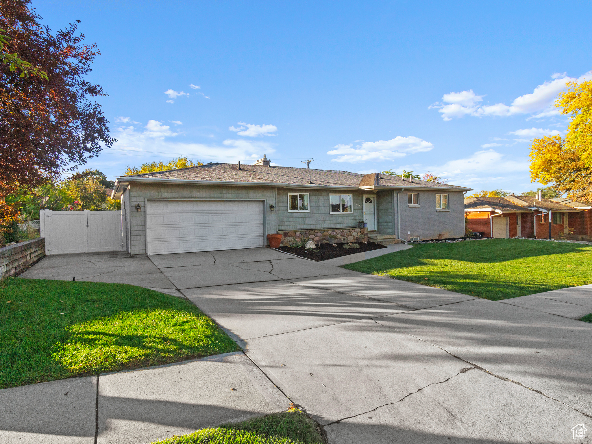 Ranch-style home with a front yard and a garage