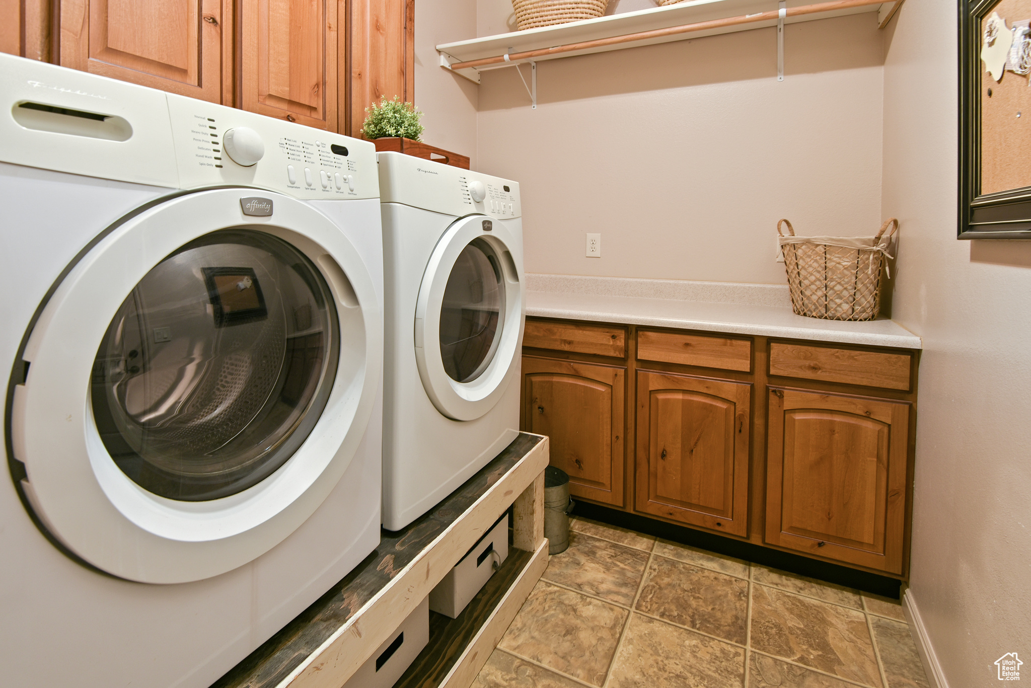 Laundry room featuring washing machine and dryer and cabinets