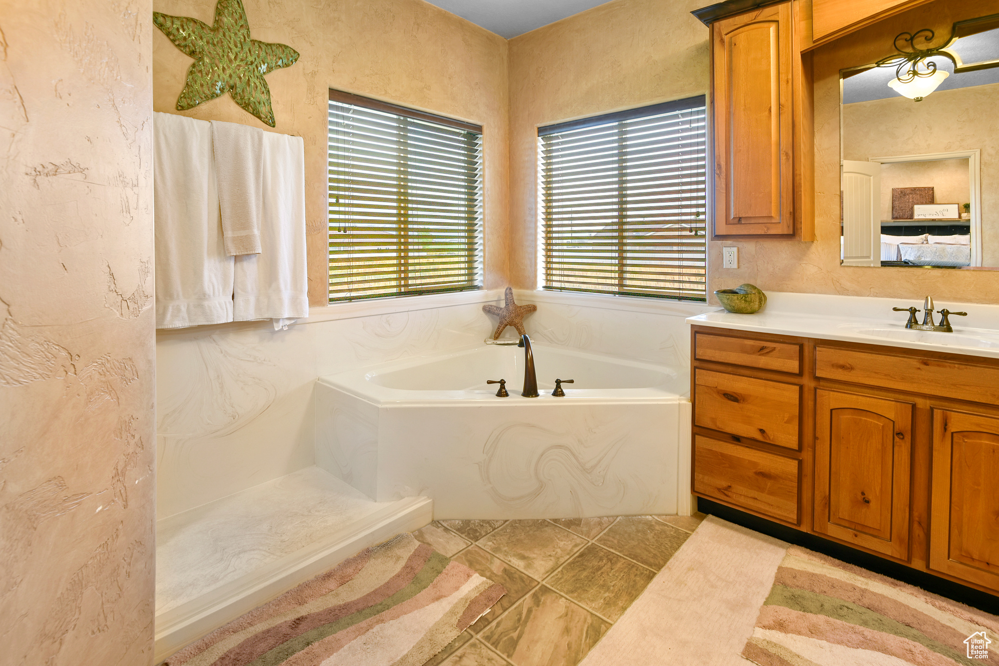 Bathroom featuring a bathing tub and vanity