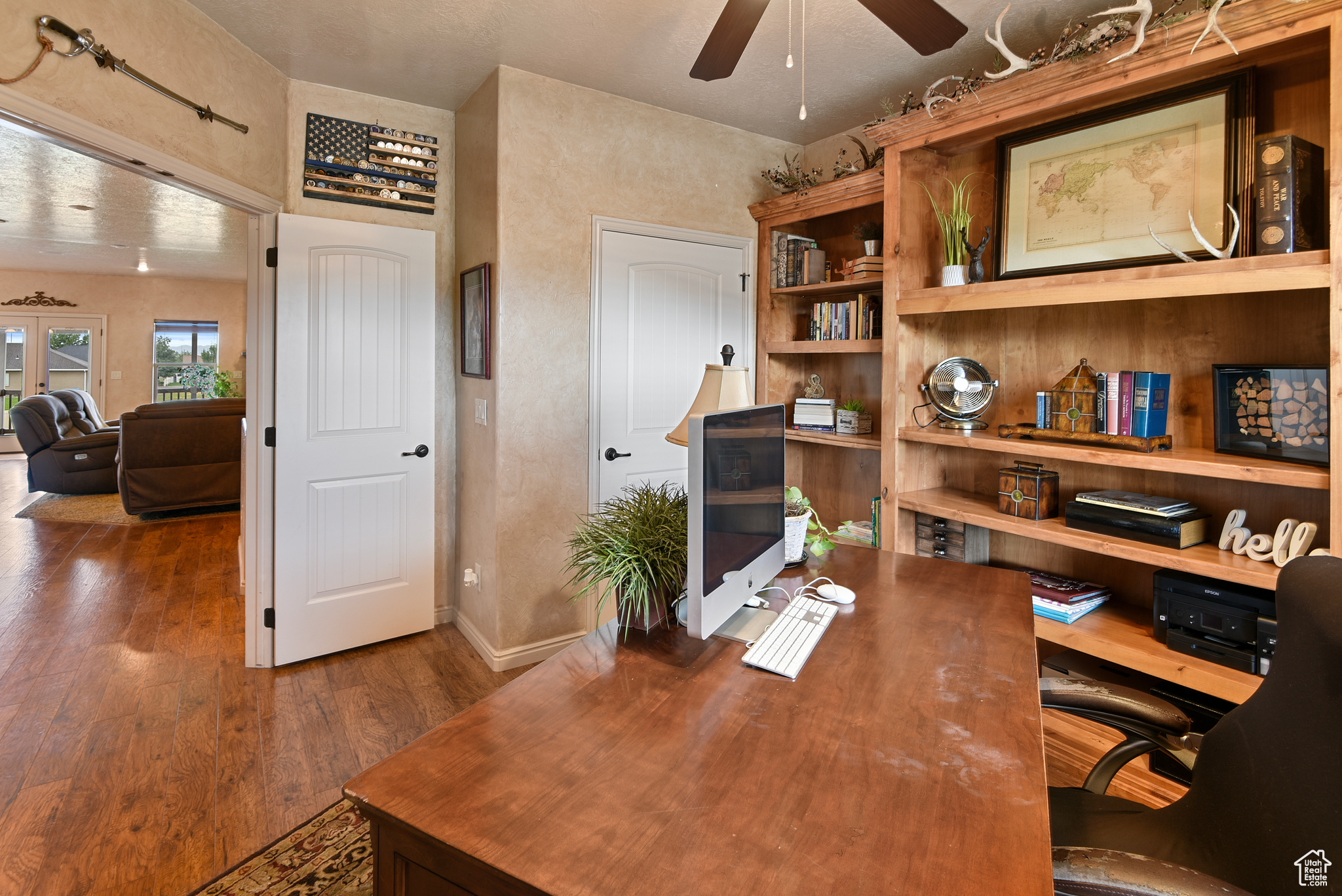 Office featuring ceiling fan, french doors, and dark hardwood / wood-style floors