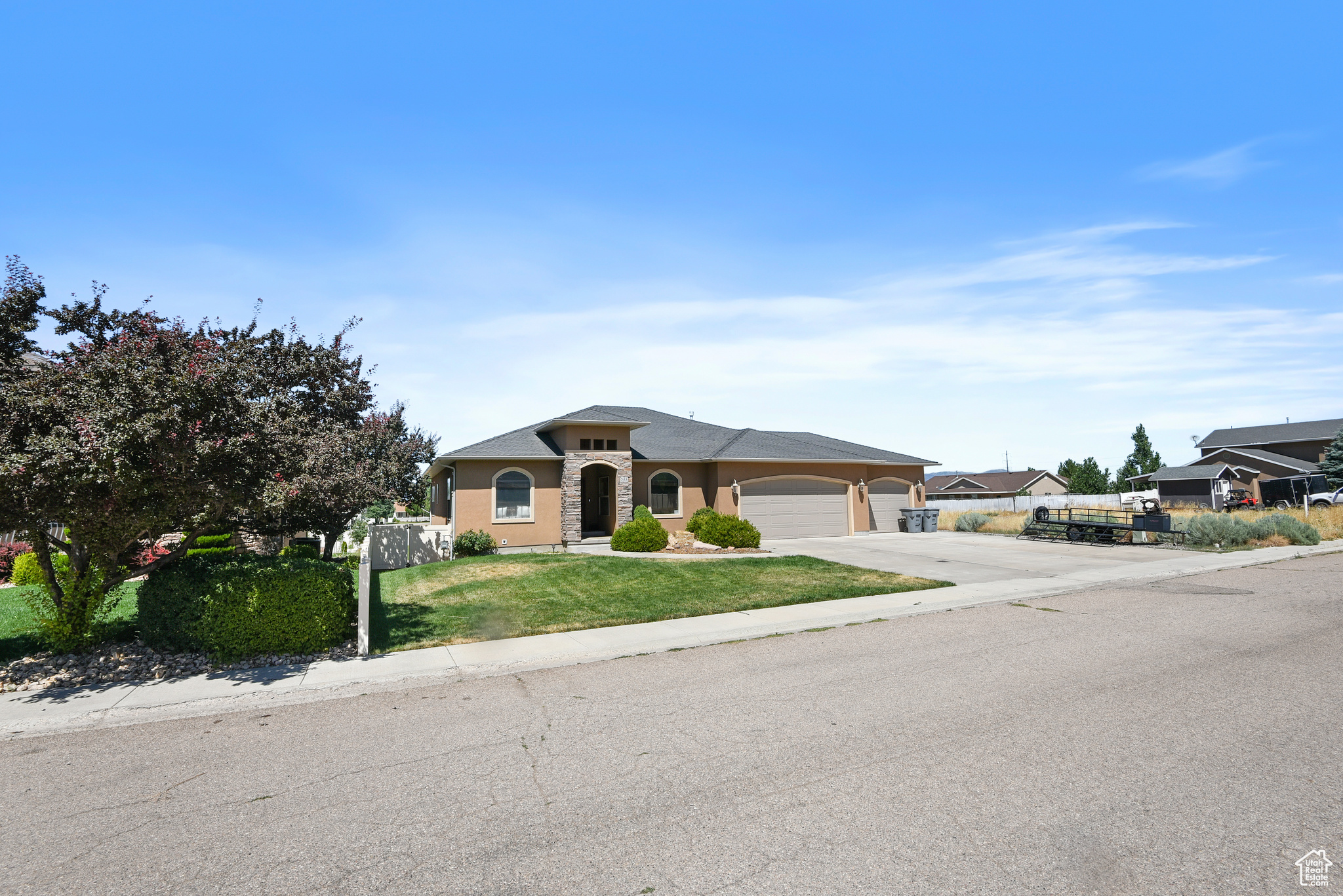 Single story home featuring a garage and a front lawn