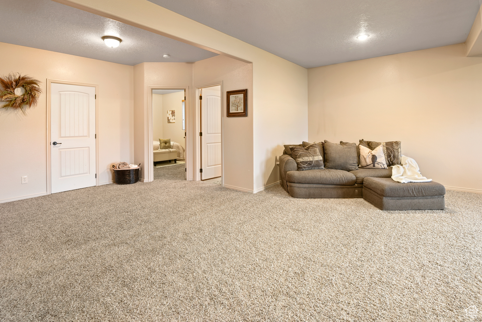 Carpeted living room with a textured ceiling