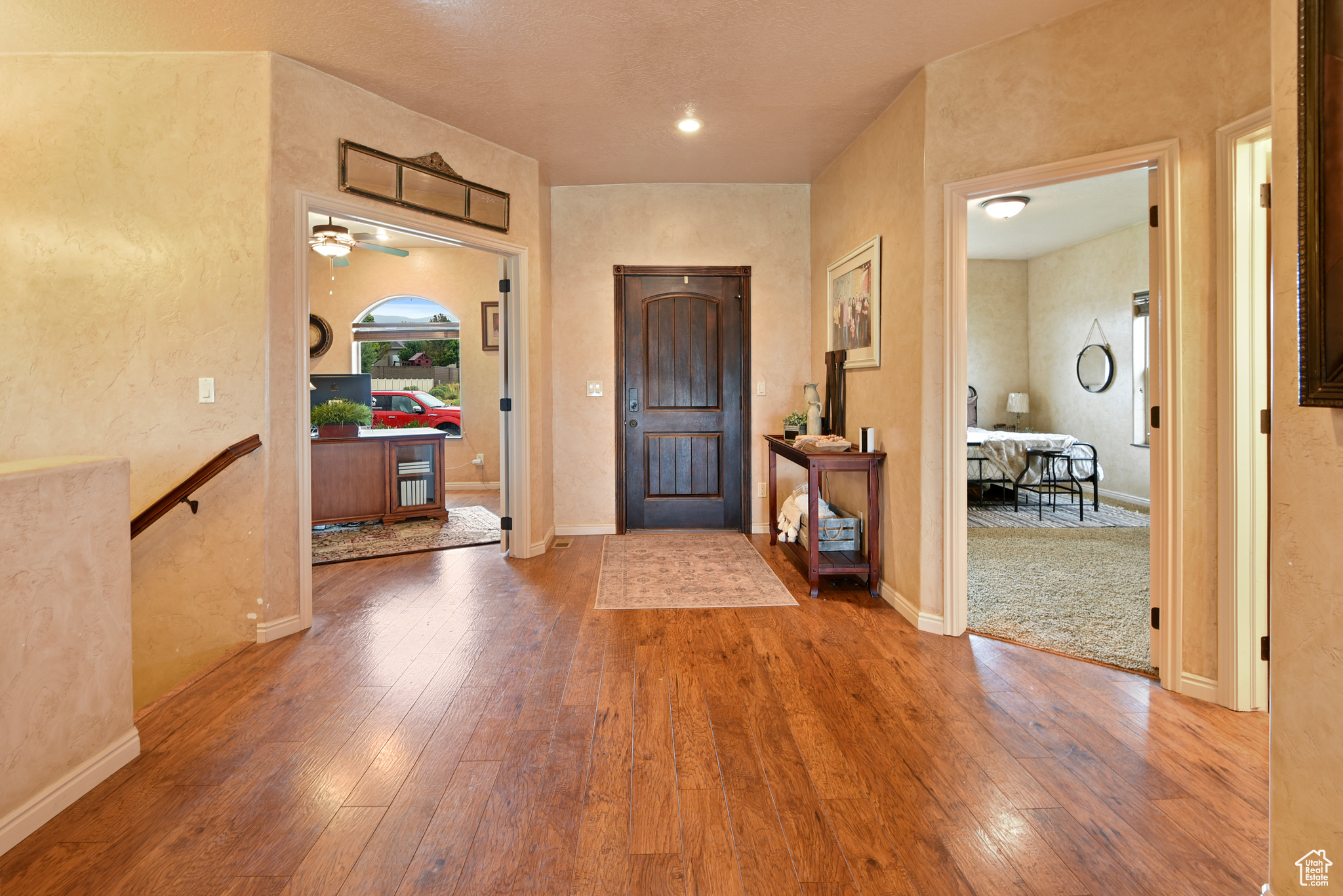 Entrance foyer featuring hardwood / wood-style floors and ceiling fan