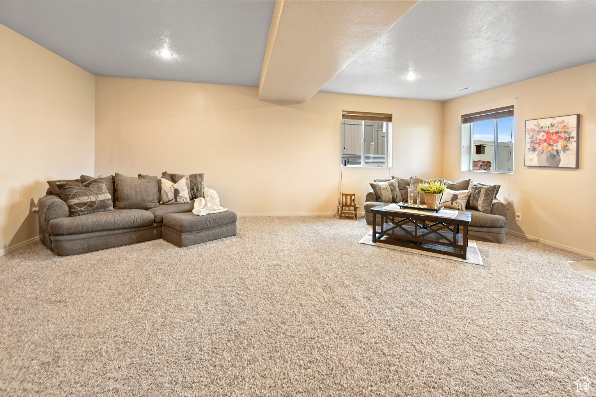 Living room featuring carpet and a textured ceiling