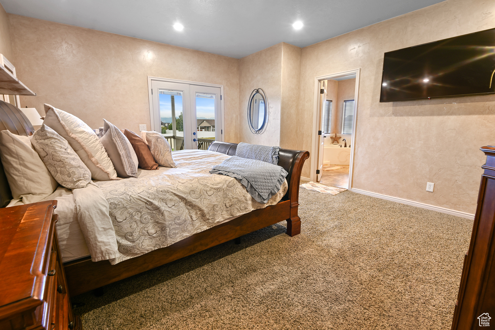 Bedroom featuring carpet flooring, access to exterior, ensuite bathroom, and french doors