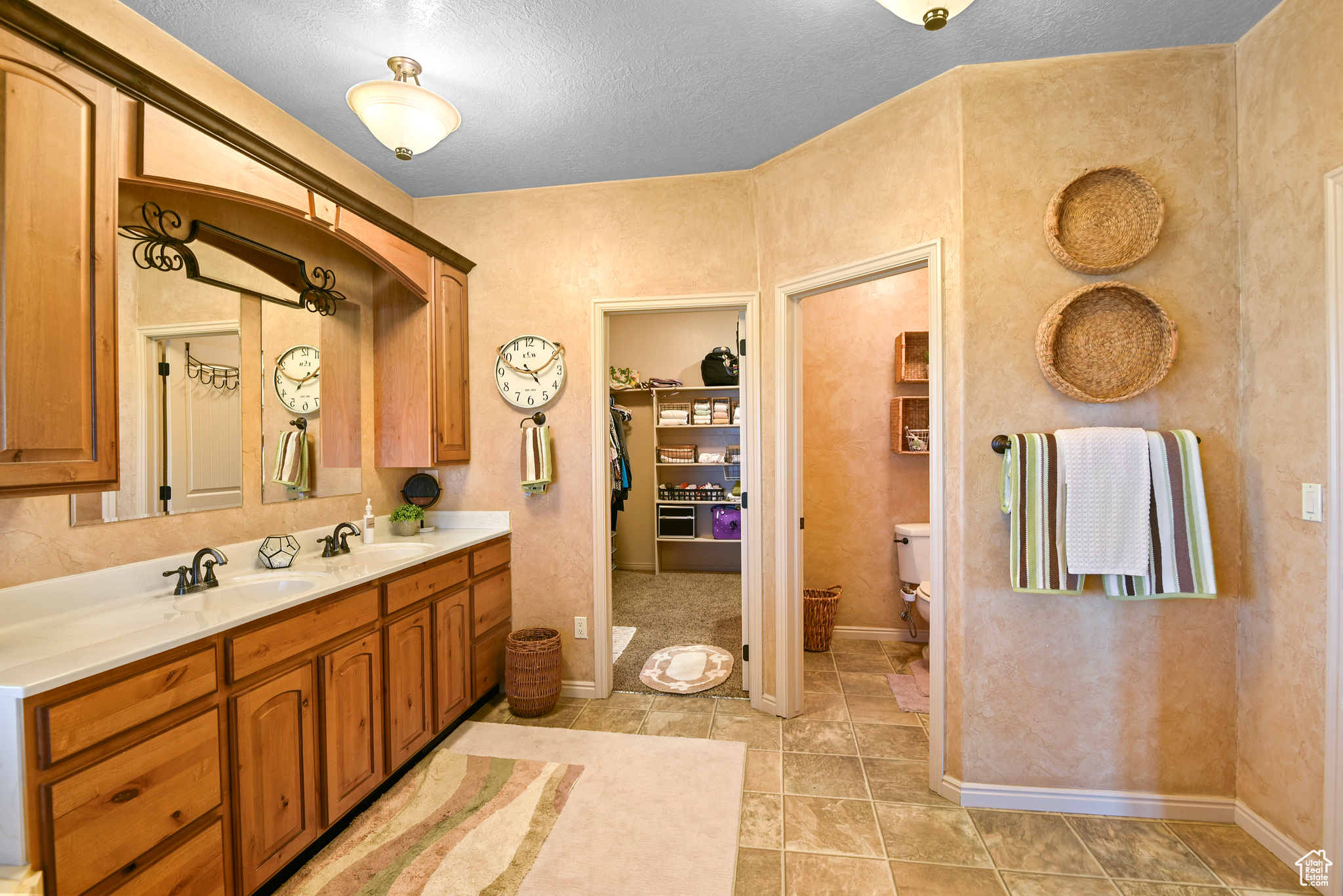 Bathroom featuring vanity, a textured ceiling, and toilet