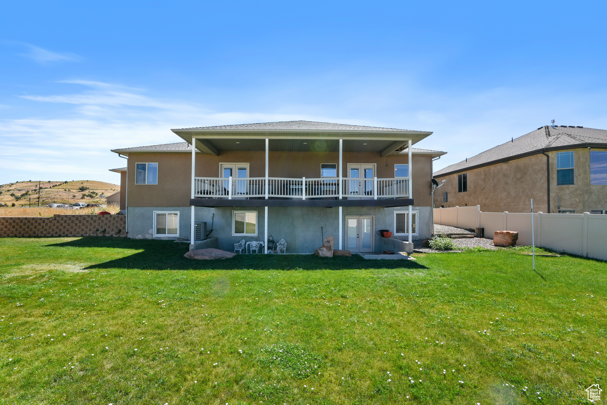 Back of property with a yard and a wooden deck