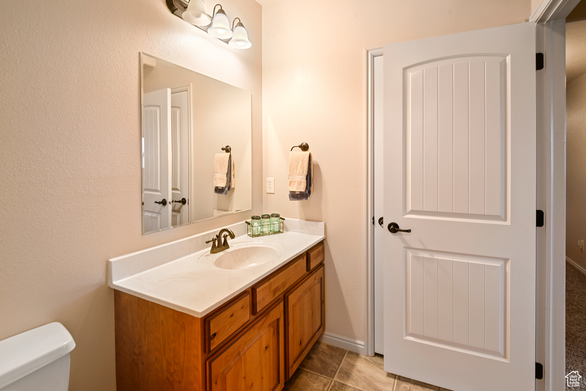 Bathroom with tile patterned flooring, vanity, and toilet