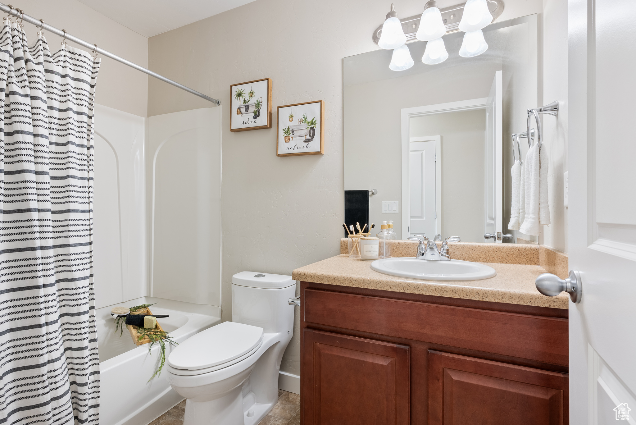 Full bathroom featuring shower / bath combo, vanity, and toilet