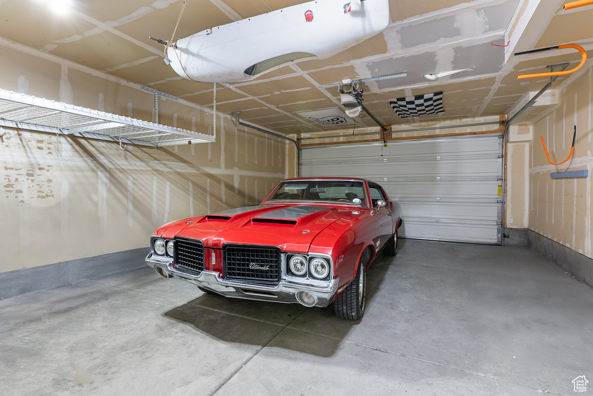 Garage featuring a carport and a garage door opener